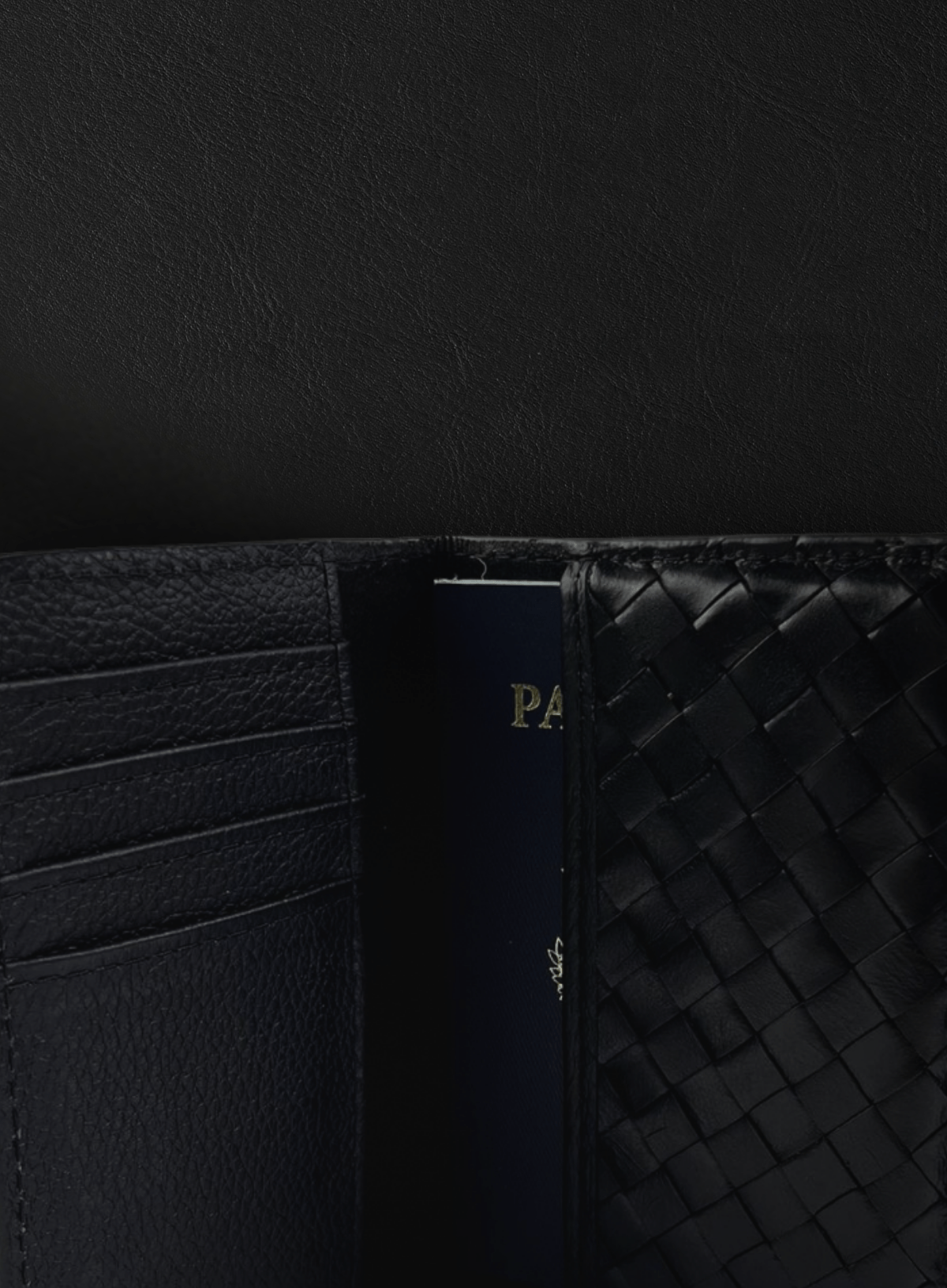 Black woven Deux Mains passport holder close-up view