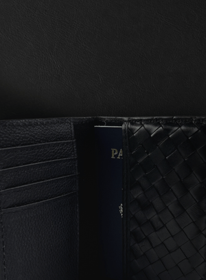 Black woven Deux Mains passport holder close-up view