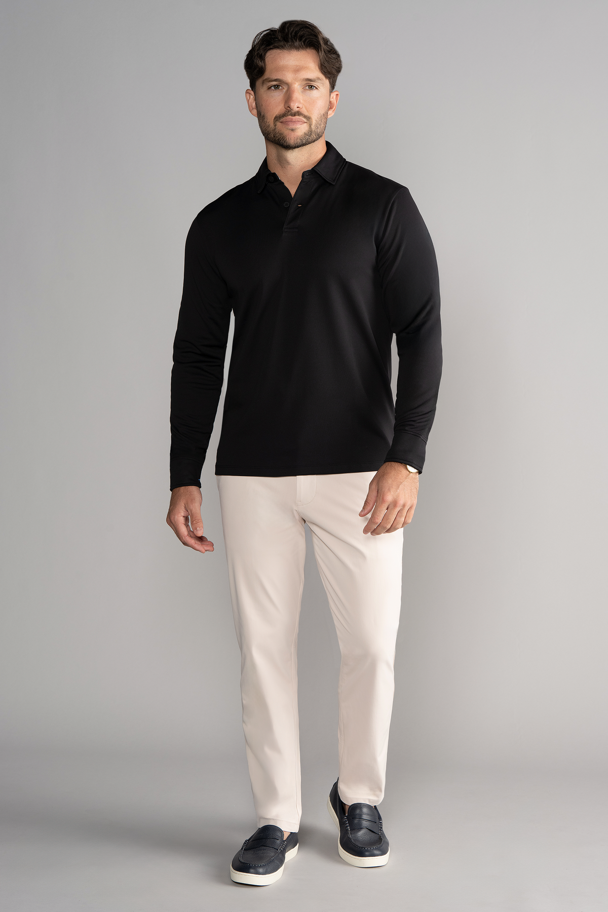 Black Twillory AthlPoloLS long sleeve polo shirt in solid black fabric, suitable for casual or athletic wear.