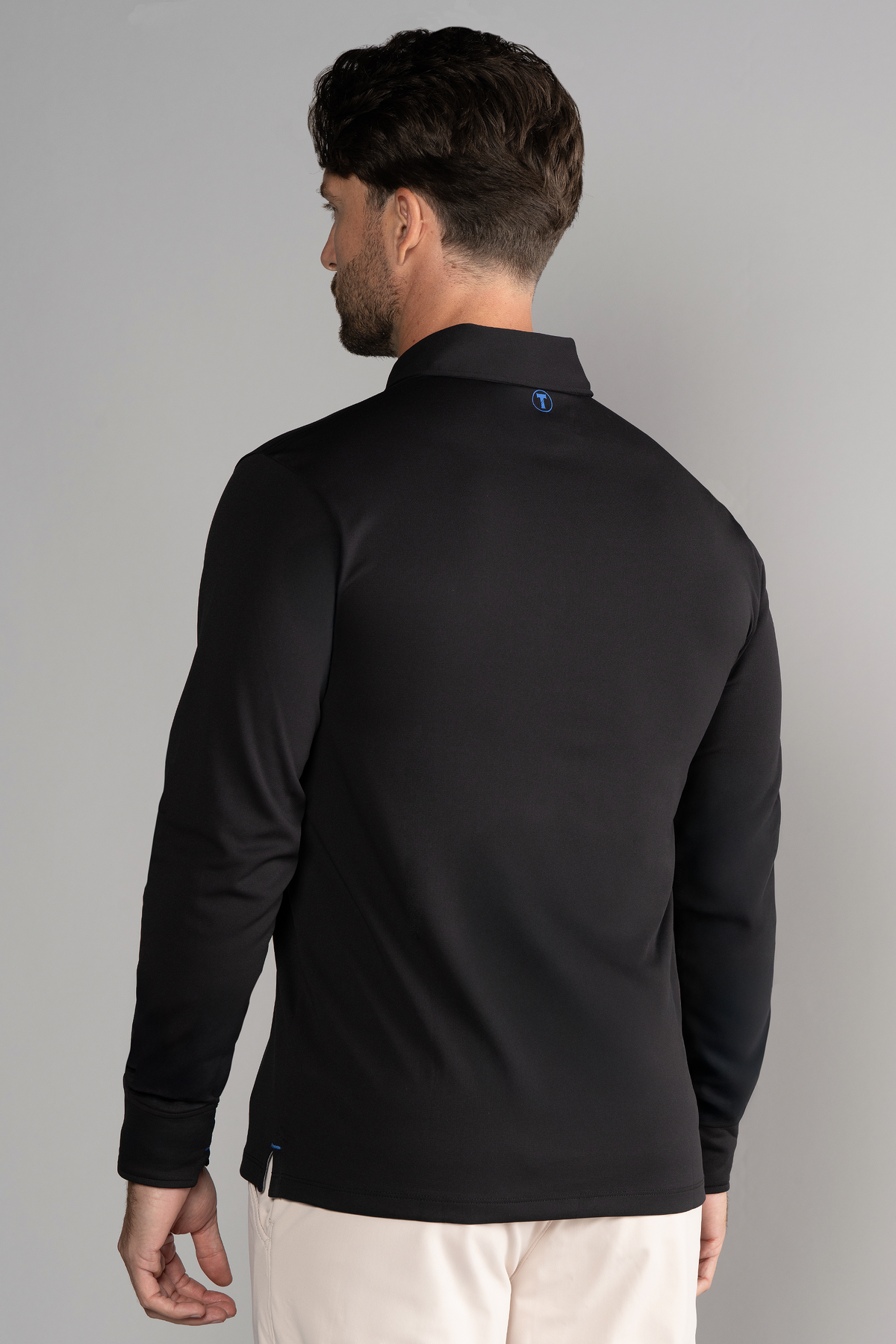 Black AthlPoloLS long sleeve polo shirt by Twillory with a solid color, shown on a mannequin.