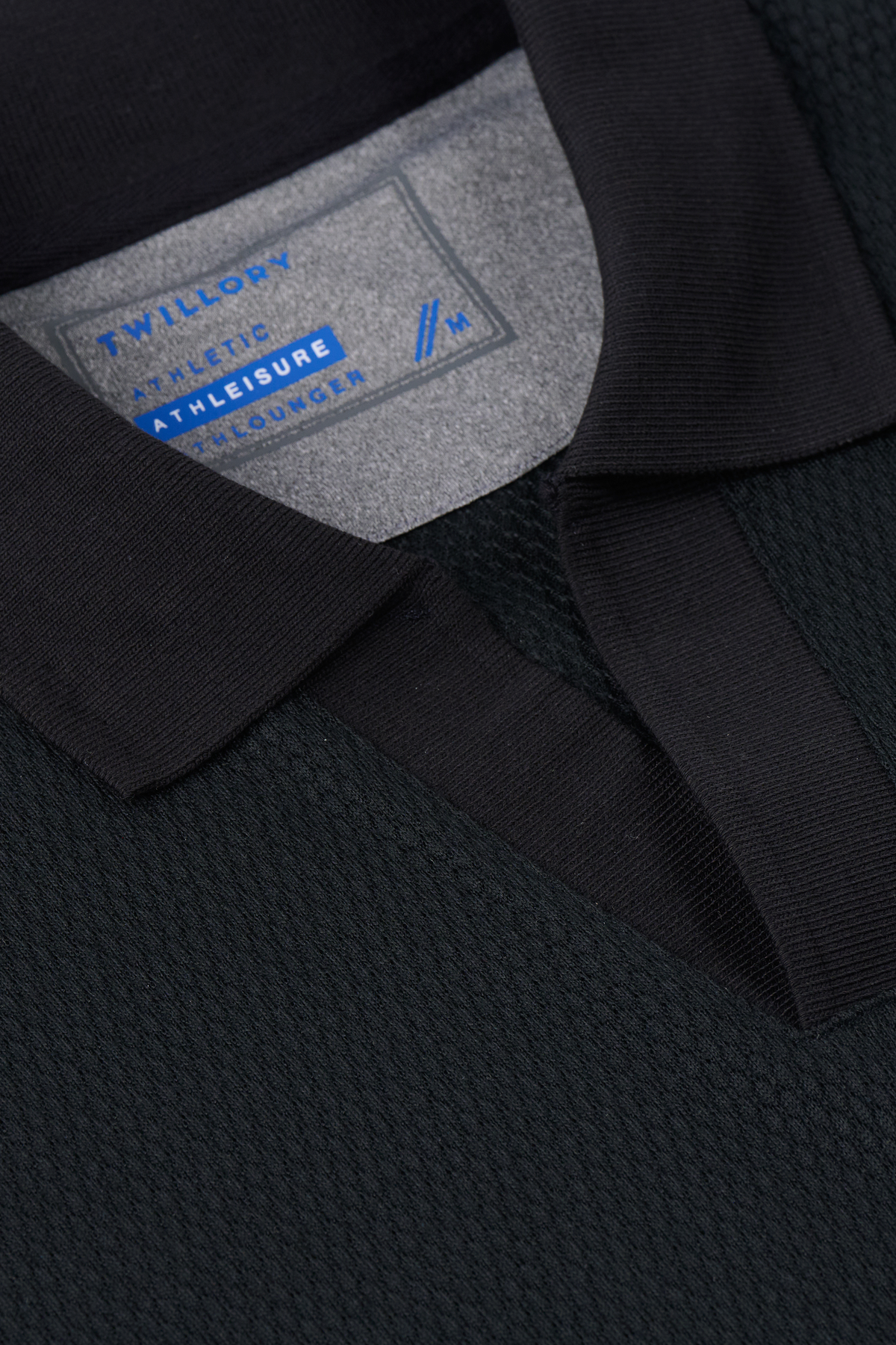 Black Twillory long sleeve sweater polo with a classic collar and ribbed cuffs, made from soft, solid fabric.