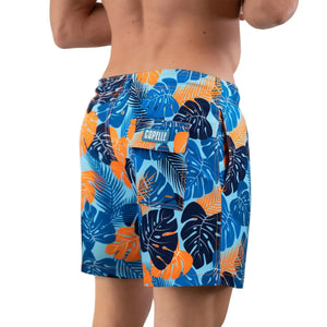 Blue Jungle hybrid swim trunks with colorful jungle print by Capelle Miami, featuring compression lining and relaxed resort style.