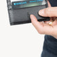 Deux Mains Call Signs card holder in black, front view held by model