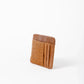 Deux Mains Slim ID Case in cognac leather, side view showing compact card holder design