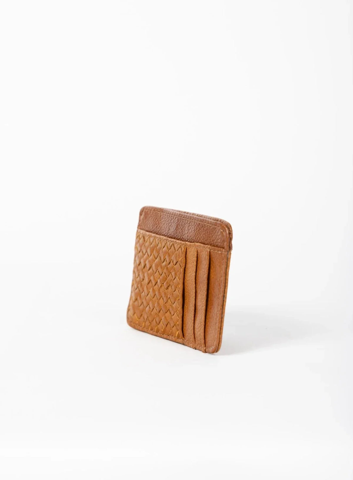 Deux Mains Slim ID Case in cognac leather, side view showing compact card holder design
