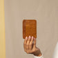 Deux Mains Slim ID Case in cognac leather, front view with card slots and ID window