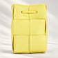 Light yellow woven mini crossbody bucket handbag by ComeBackDude, featuring a lightweight shoulder strap and compact design.