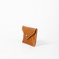 Deux Mains cognac leather coin pouch, side view