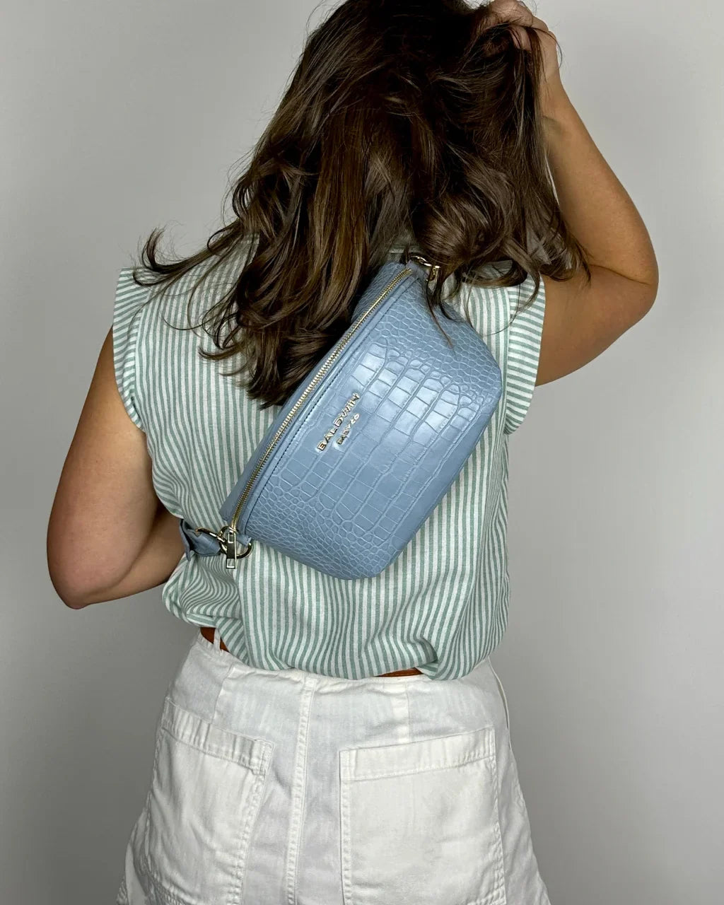 Baldwin Baby Company Ono Zephyr blue crossbody belt bag diaper bag, modeled from back