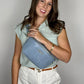 Baldwin Baby Company Ono Crossbody Belt Bag in blue, worn across the front as a diaper bag