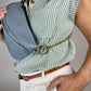 Baldwin Baby Company Ono Crossbody Belt Bag in blue, modeled with visible hardwareWinvalid
