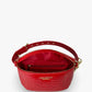 Baldwin Baby Company Ono Crossbody Belt Bag in cardinal red, showing the spacious interior compartments