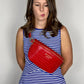 Baldwin Baby Company Ono Crossbody Belt Bag in cardinal red, modeled front view