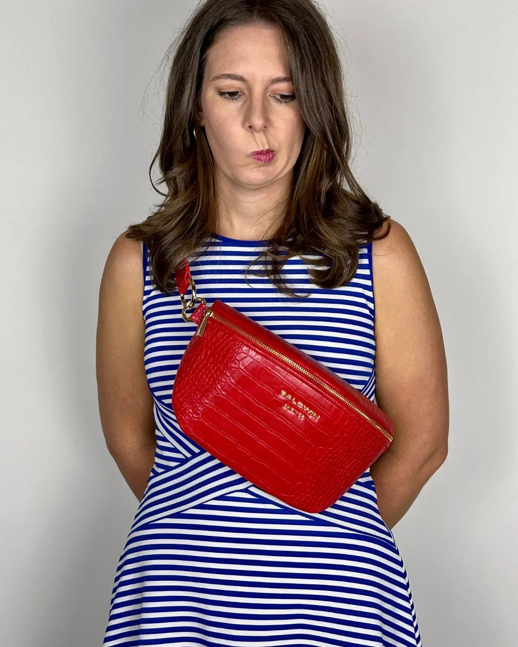 Baldwin Baby Company Ono Crossbody Belt Bag in cardinal red, modeled front view