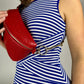 Baldwin Baby Company Ono Crossbody Belt Bag in cardinal red, modeled with visible hardware and adjustable strap