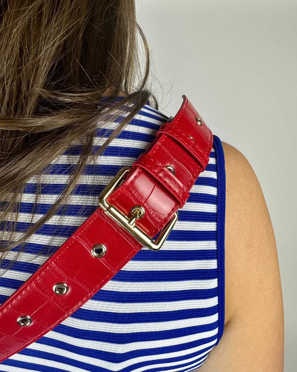 Baldwin Baby Company Ono Cardinal red crossbody belt bag diaper bag worn as a shoulder bag