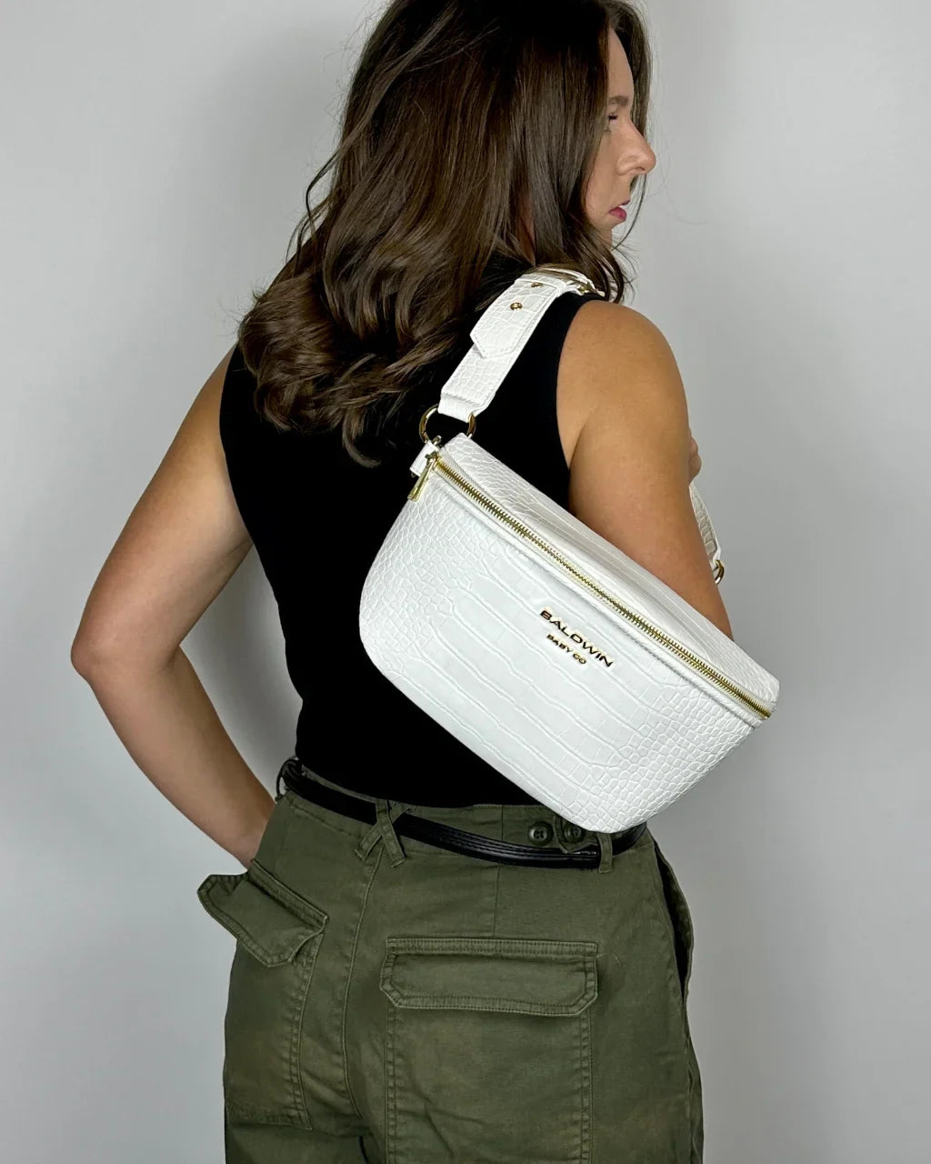 Baldwin Baby Company Ono Crossbody Belt Bag in white, modeled from the back as a diaper bag