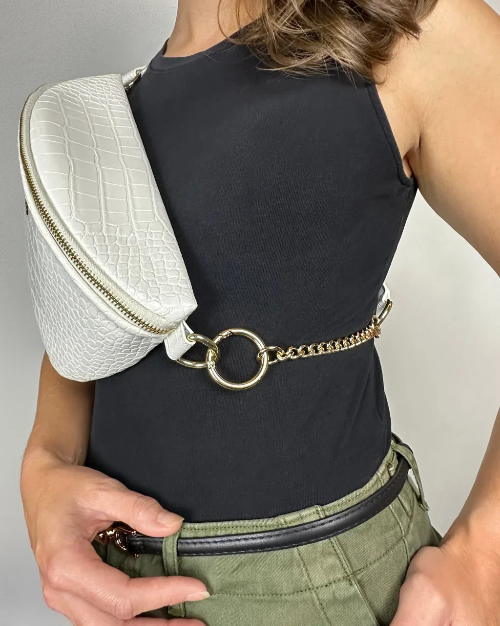 Baldwin Baby Company Ono Crossbody Belt Bag diaper bag in white with adjustable strap and hardware shown.