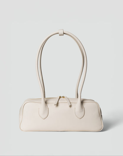 HYER GOODS La Strada East West shoulder bag in off-white leather with sleek design and minimal hardware.