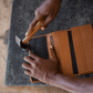 Deux Mains woven wristlet wallet shown in a behind-the-scenes factory setting