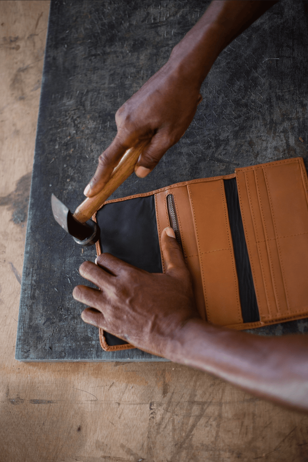 Deux Mains woven wristlet wallet shown in a behind-the-scenes factory setting