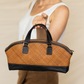 Deux Mains East-West handbag close-up in leather with structured shape and top handles