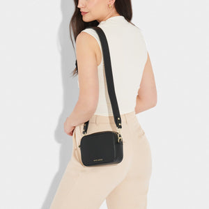 Black Zana Mini Crossbody Bag by KADOU BOUTIQUE, compact leather bag with adjustable strap and minimalist design.