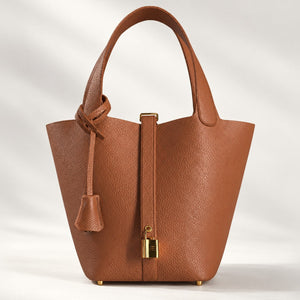 Brown leather bucket bag with drawstring pouch and mini lock design, ComeBackDude leather satchel for everyday use.