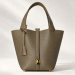 Leather bucket bag with drawstring pouch and mini lock, ComeBackDude leather satchel for everyday use, in etoupe color.