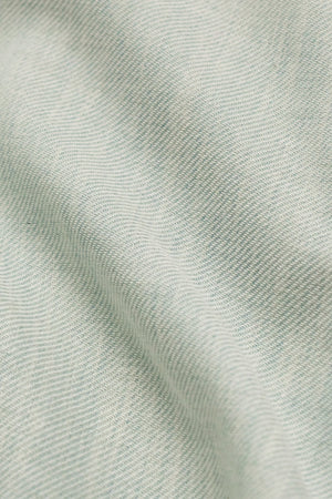 Green Twillory Performance Linen Shirt displayed on a hanger, showcasing lightweight, breathable linen fabric and casual style.