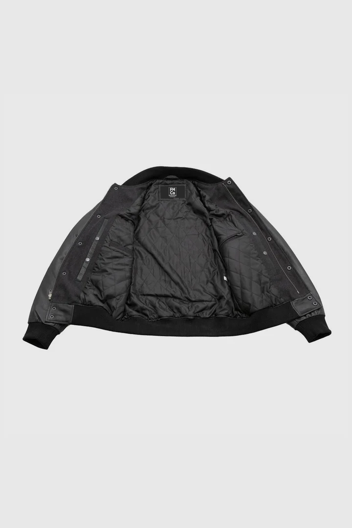 Inside view of Whet Blu NYC men's varsity bomber jacket showing striped ribbed collar and quilted lining