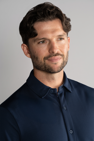 Navy long sleeve button-down polo shirt by Twillory, solid color, classic fit, with collar and buttoned cuffs.
