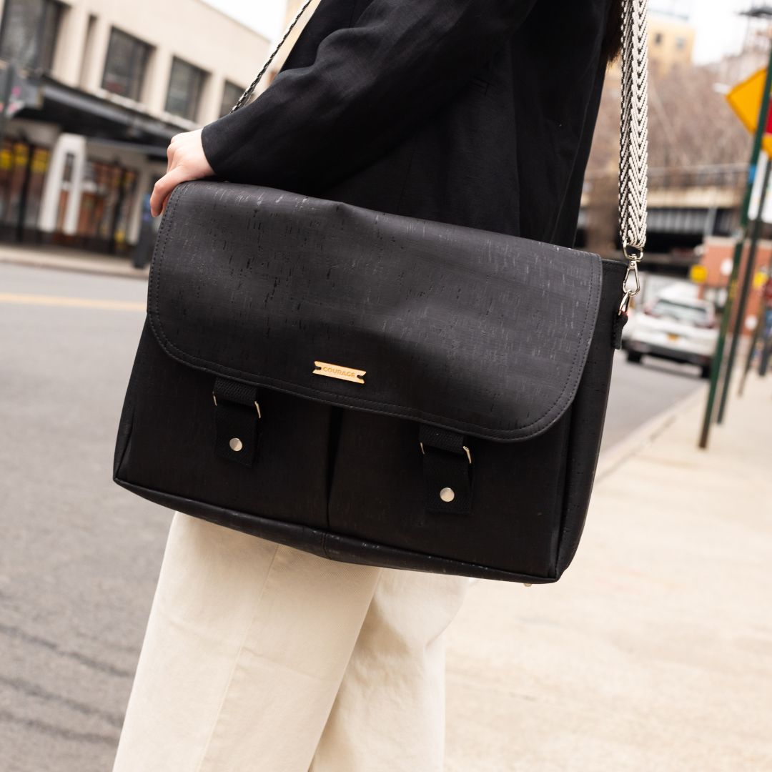 Carry Courage NOMAD messenger bag in coal gray, showing a compact crossbody design with adjustable strap