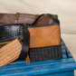 Deux Mains Panye crossbody bag in tan leather with adjustable strap and structured bench-inspired design