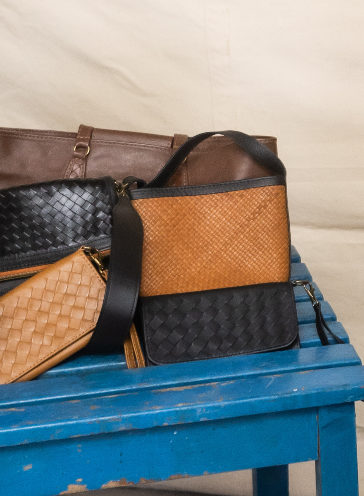 Deux Mains Panye crossbody bag in tan leather with adjustable strap and structured bench-inspired design