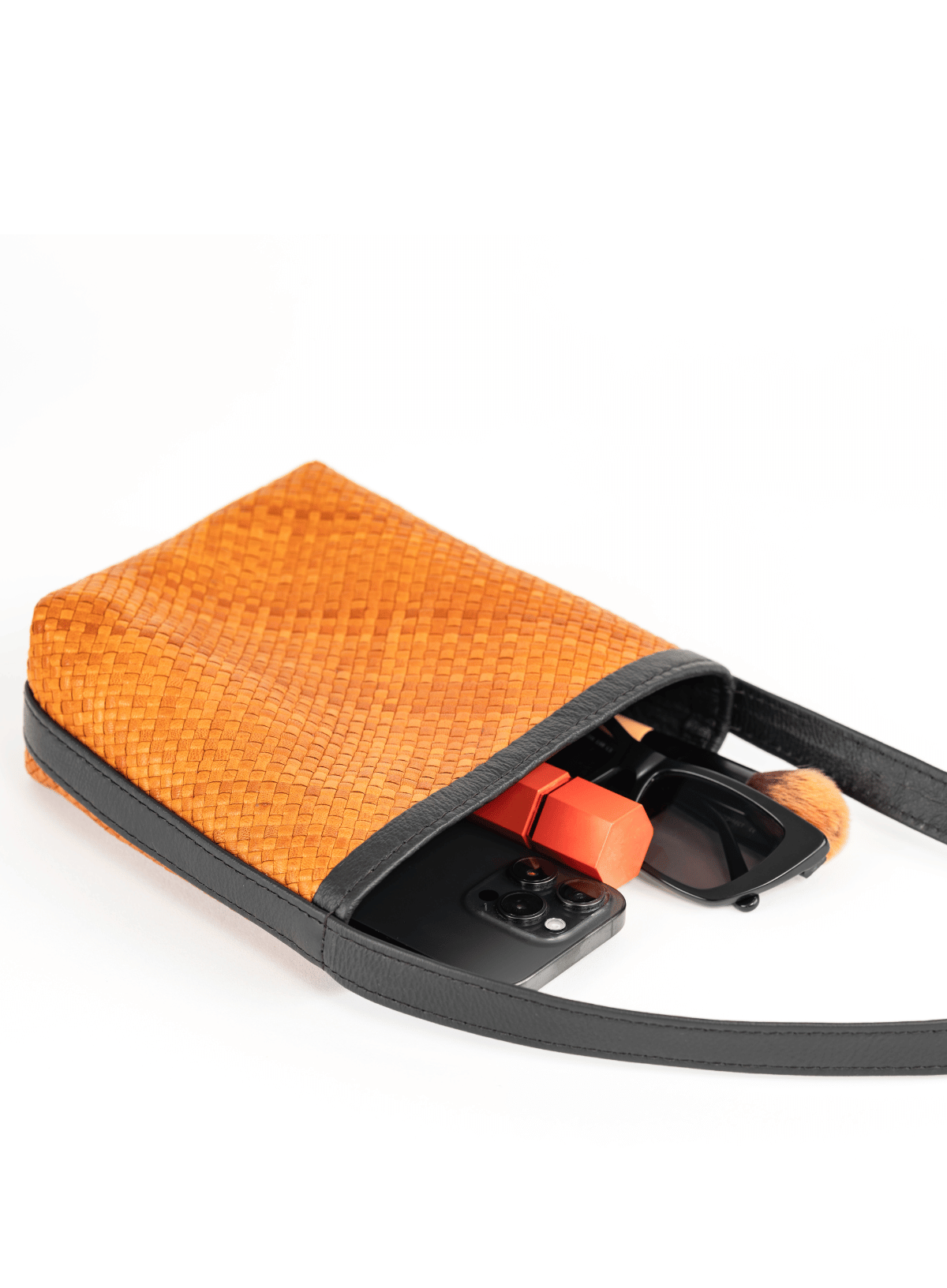 Interior detail of the Deux Mains Panye crossbody bag, showing organized compartments and lining
