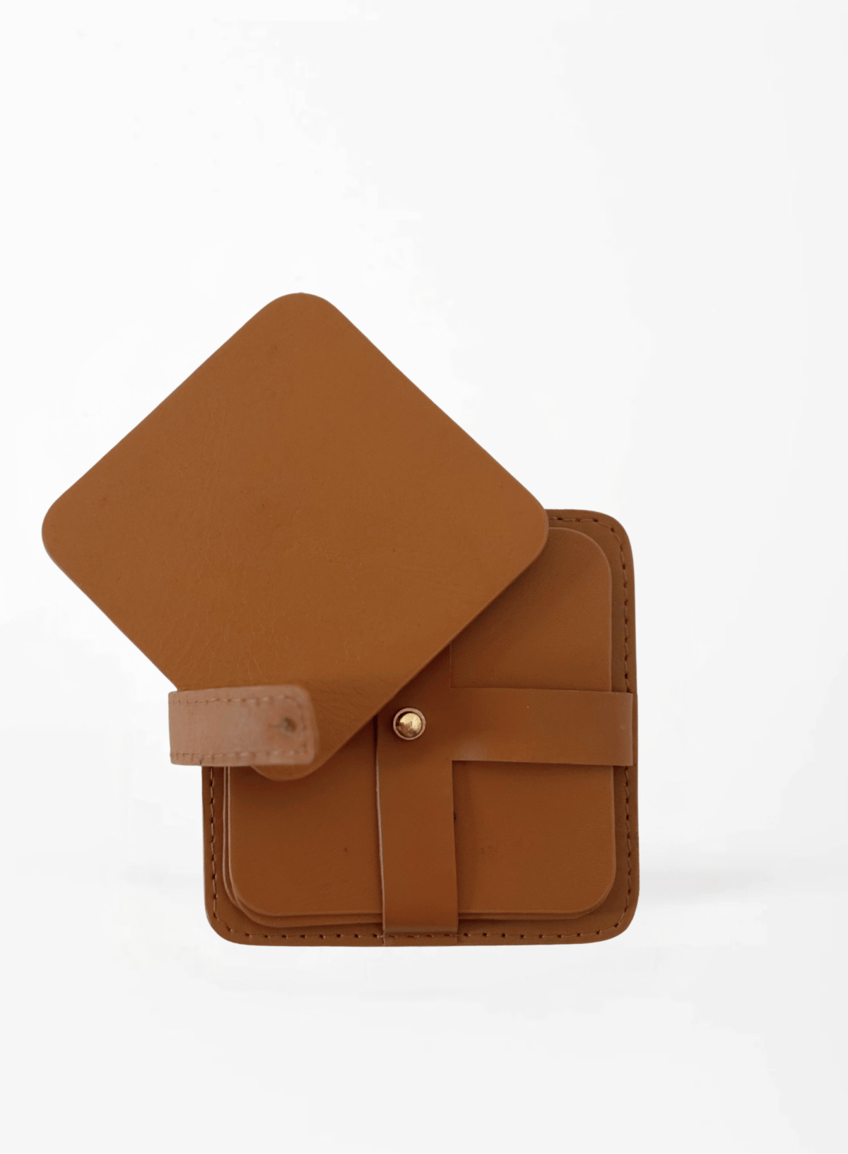 Deux Mains cognac square coasters set of 4 with holder in a corporate interior setup