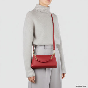 Red Italian full-grain leather crossbody bag by TAKEASY, featuring a compact design with a flap closure and adjustable strap.