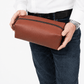 Deux Mains Iron Tight toiletry bag in cognac leather, compact rectangular design with zipper closure