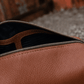 Interior of Deux Mains Iron Tight toiletry bag in cognac leather with organized compartments