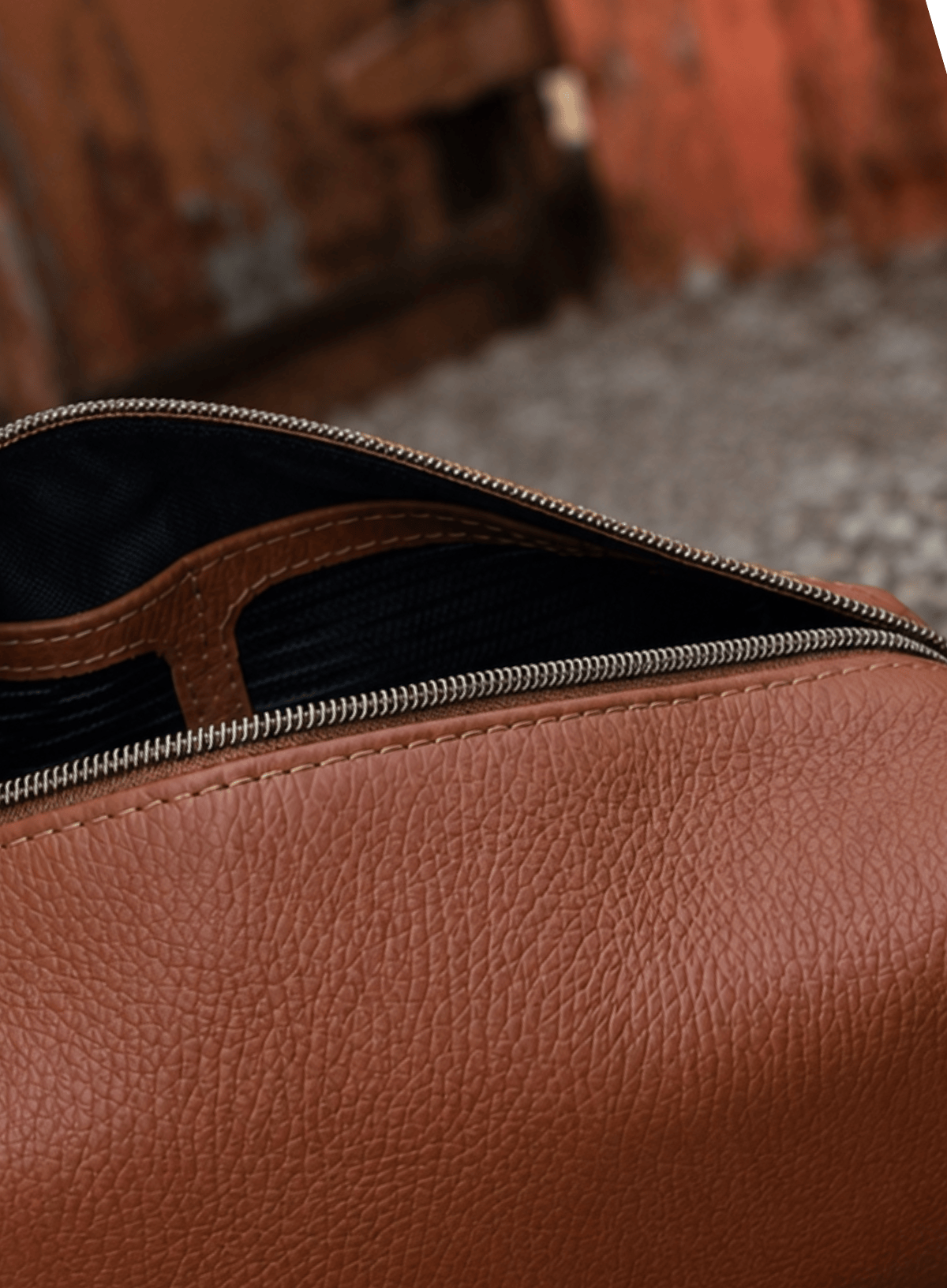 Interior of Deux Mains Iron Tight toiletry bag in cognac leather with organized compartments