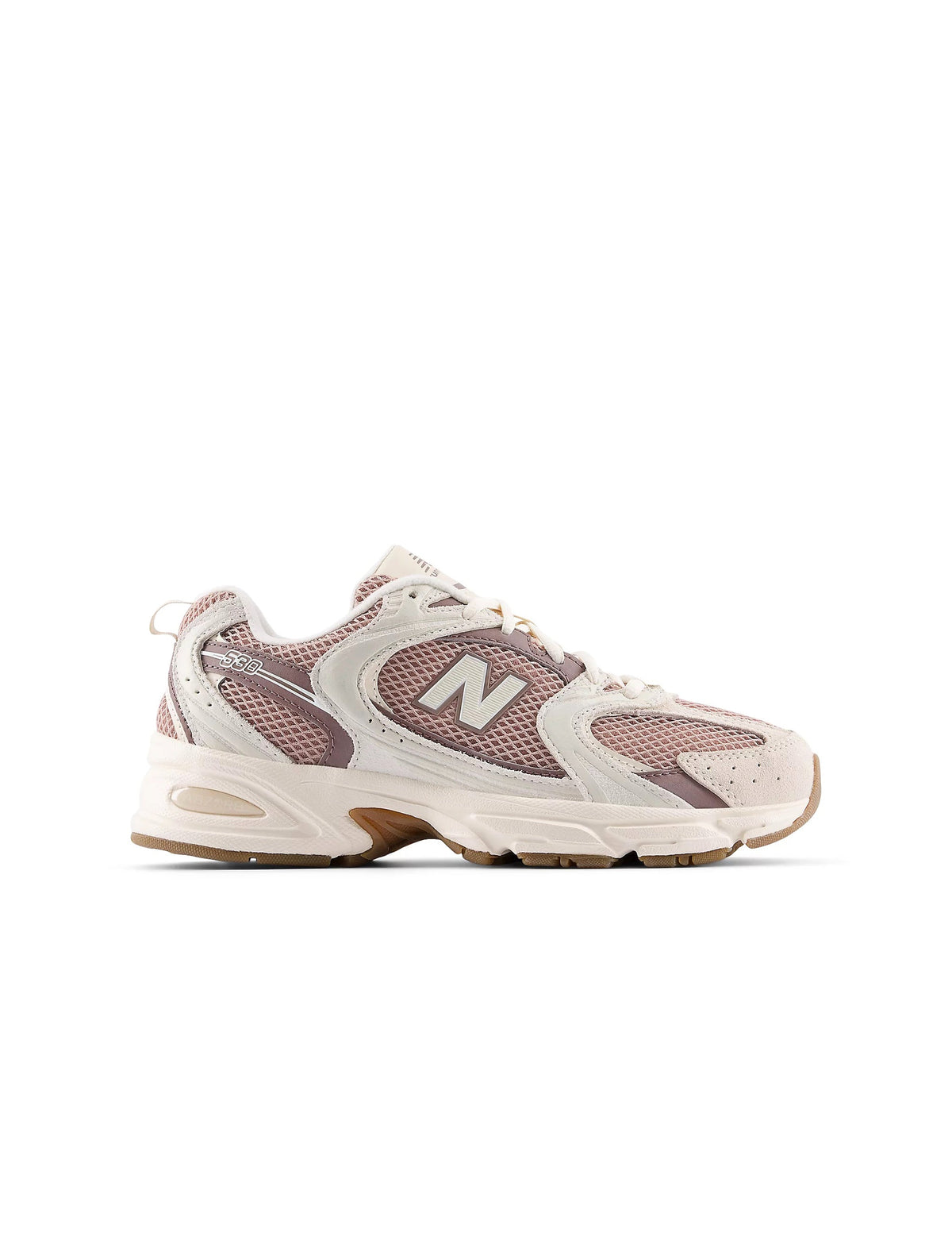 Beige and brown New Balance Women's 530 running shoes in a natural outdoor setting, showcasing sporty design and breathable material.