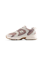 Beige and brown New Balance Women's 530 running shoes with breathable mesh and supportive sole, designed for comfort and performance.