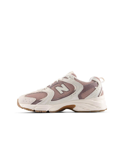 Beige and brown New Balance Women's 530 running shoes with breathable mesh and supportive sole, designed for comfort and performance.