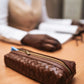 Deux Mains brown woven pencil case, close-up of textured handcrafted design