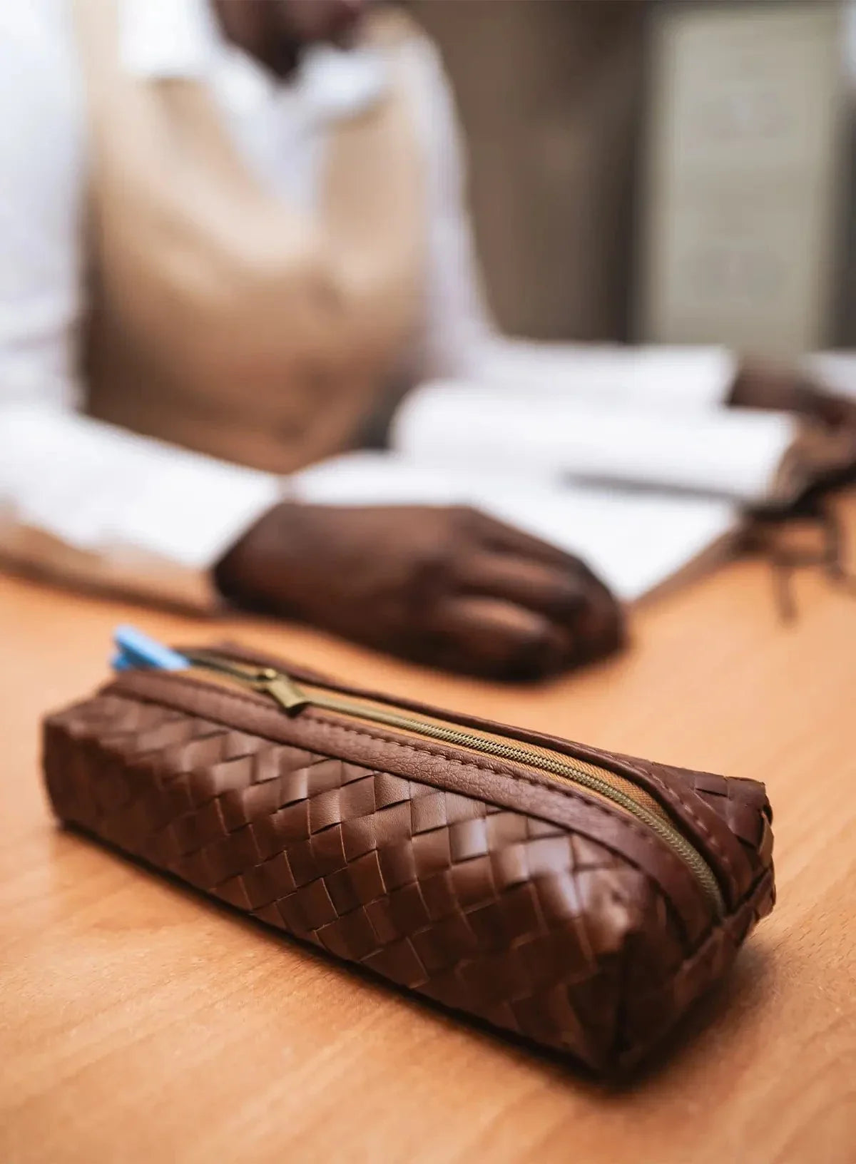 Deux Mains brown woven pencil case, close-up of textured handcrafted design