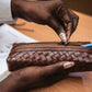 Deux Mains woven pencil case in brown leather with textured woven design