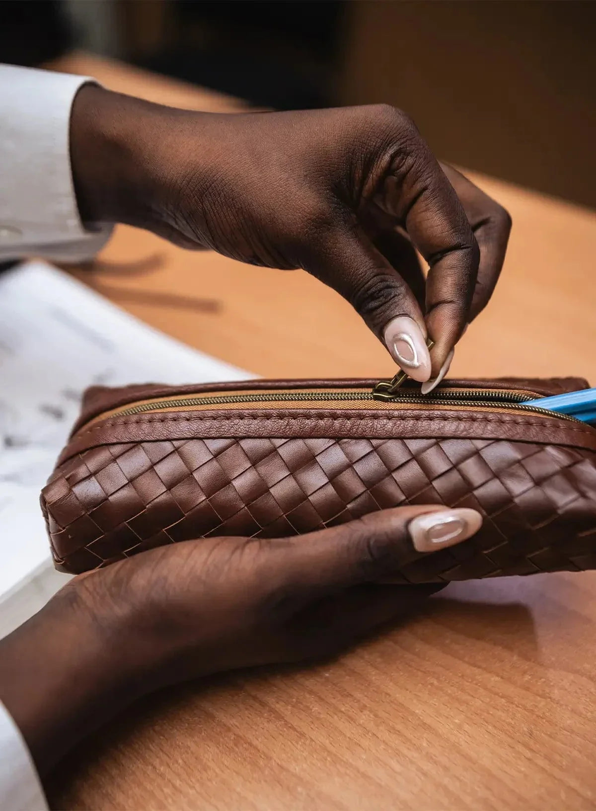 Deux Mains woven pencil case in brown leather with textured woven design