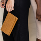 Deux Mains woven wristlet wallet in cognac leather, close-up view