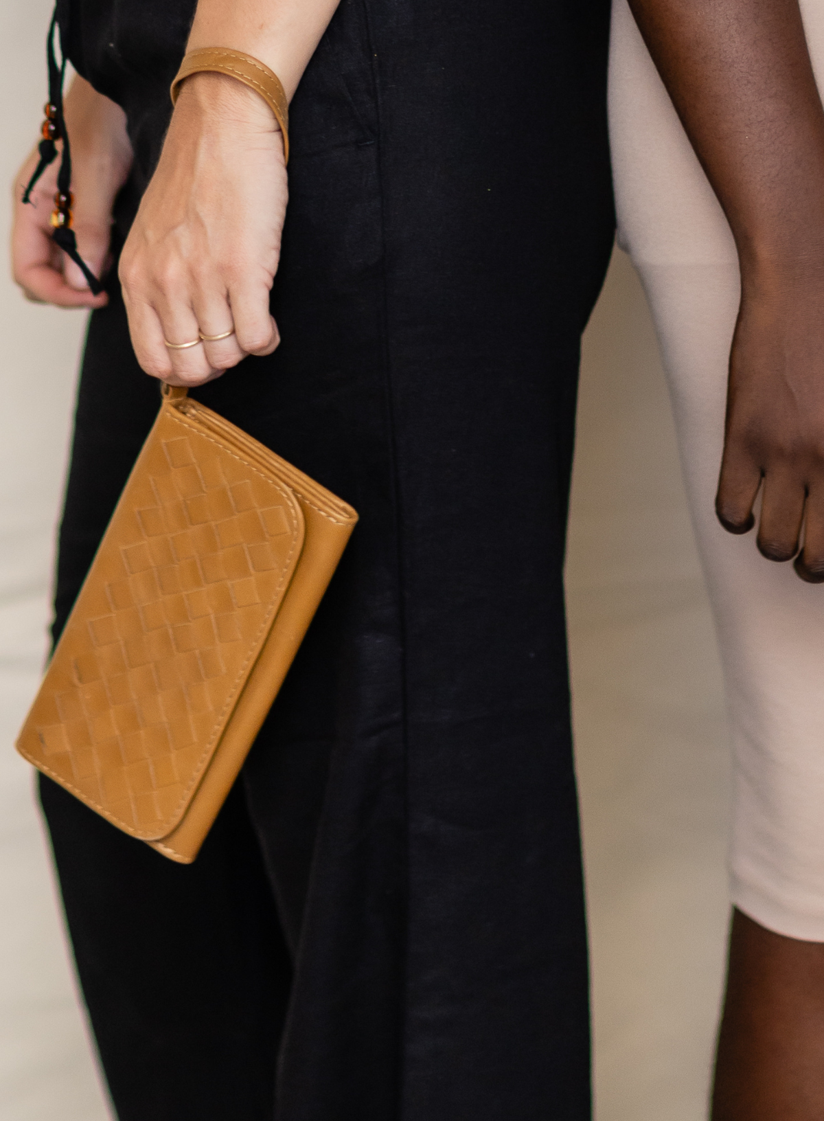 Deux Mains woven wristlet wallet in cognac leather, close-up view